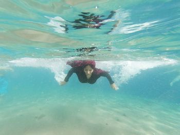 Woman swimming undersea