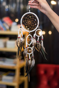 Cropped hand holding dreamcatcher