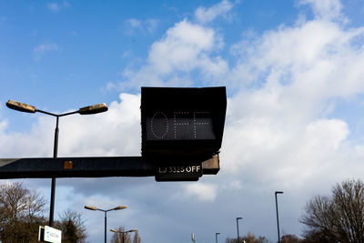 Low angle view of road sign against sky