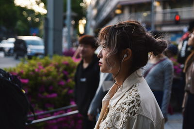 Portrait of woman looking at city street