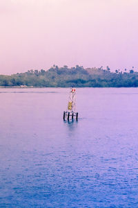 Scenic view of sea against clear sky during sunset