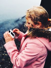 Close-up of girl using camera