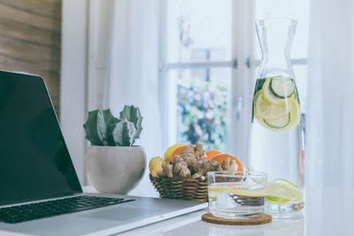 Morning time at home healthy breakfast laptop and drink. natural meal and fruits at work in office 