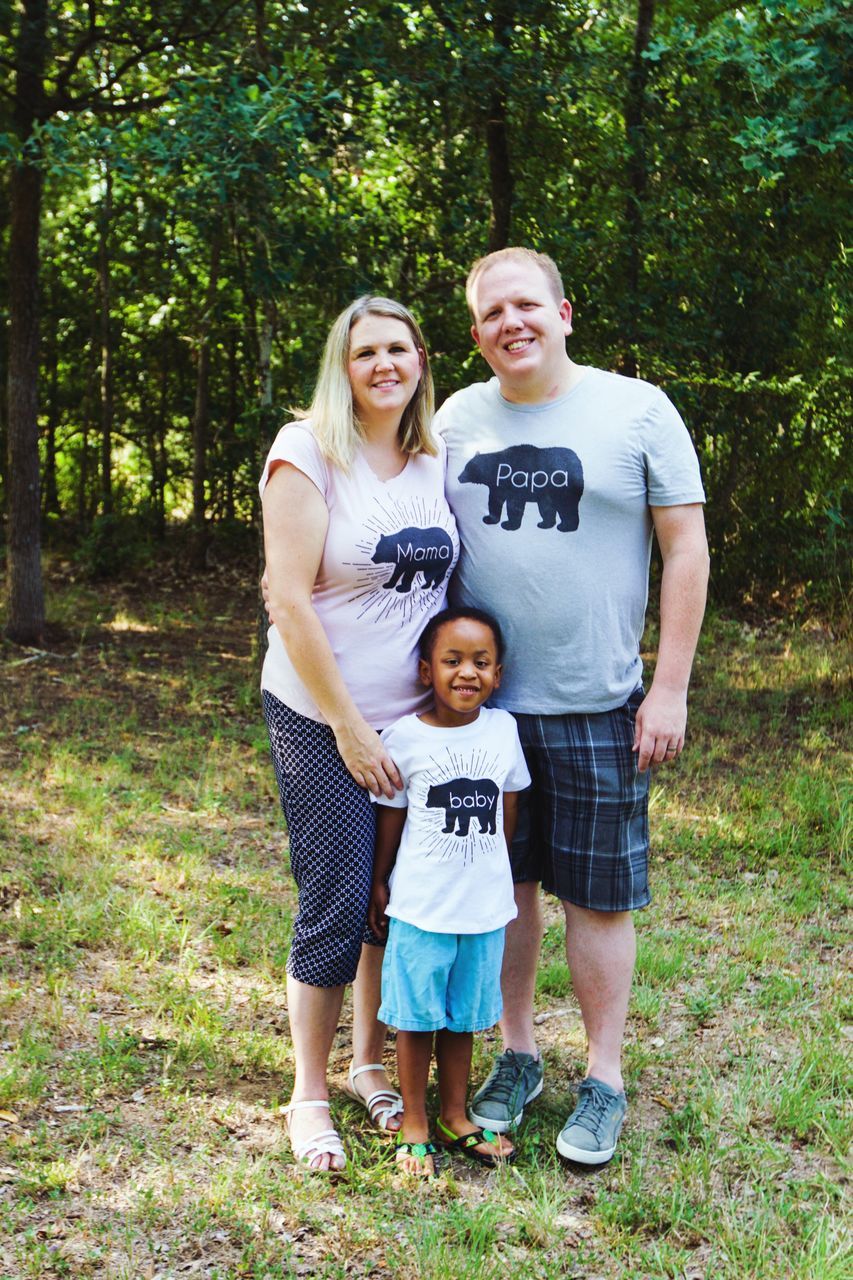 mother, togetherness, standing, family, mid adult, tree, father, casual clothing, mid adult men, daughter, happiness, full length, love, mid adult women, forest, real people, day, childhood, nature, front view, girls, men, portrait, boys, son, growth, smiling, outdoors, looking at camera, child, bonding, women, young women, adult, young adult, people