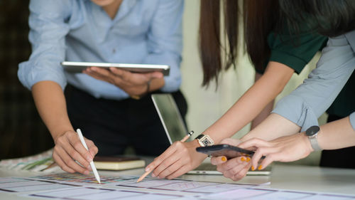 Midsection of woman working on table