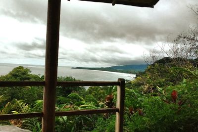 Scenic view of calm sea against cloudy sky