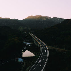 High angle view of road by mountain against sky