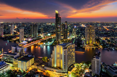 High angle view of illuminated buildings against sky during sunset