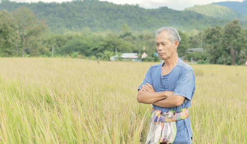 Portrait of young man standing on field