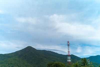 Low angle view of communications tower against sky