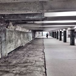 Rear view of man walking in corridor