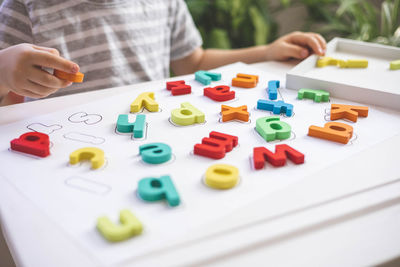 Midsection of woman with dices on table