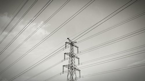 Low angle view of electricity pylon against sky