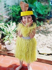 Portrait of smiling girl wearing costume standing outdoors