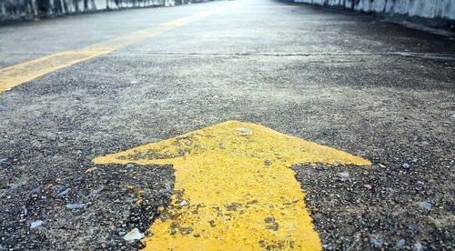 Yellow arrow symbol on road in city