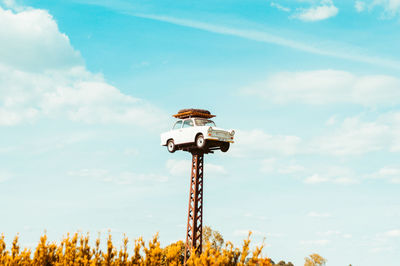 Low angle view of crane against sky