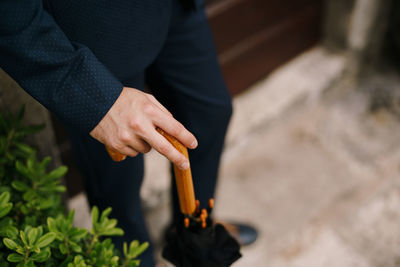 Midsection of man holding fire