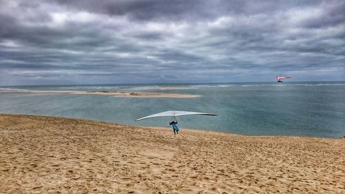 Scenic view of sea against cloudy sky