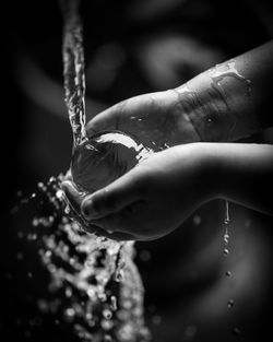 Close-up of hand touching water