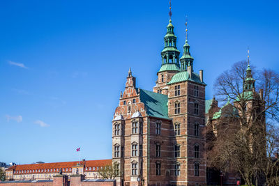 Low angle view of historical building against blue sky