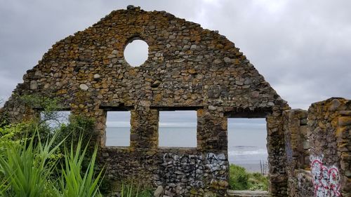 Low angle view of old ruins against sky