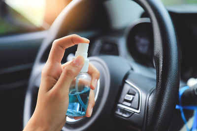 Close-up of person using laptop in car