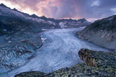 Scenic view of snowcapped mountains against sky during sunset