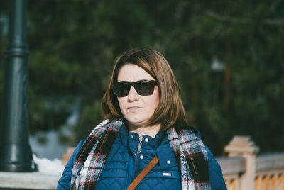 Woman wearing sunglasses and warm clothing during winter