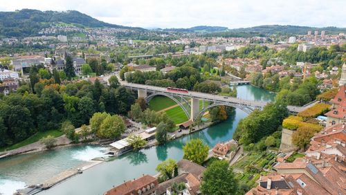 High angle view of bridge over river amidst buildings in city