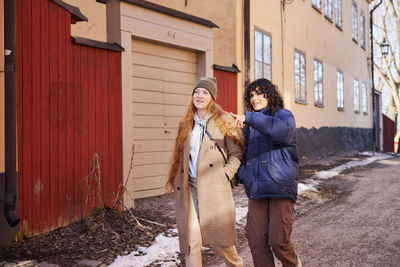 Smiling young women walking in street