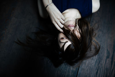 High angle view of woman lying on wood