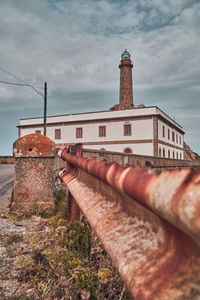 Low angle view of old building against cloudy sky