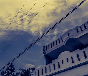 Low angle view of building against cloudy sky