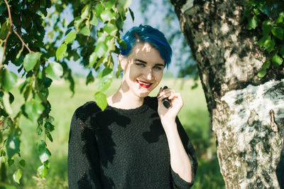 Close-up of young woman holding electronic cigarette