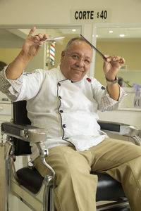 Portrait of a smiling young man sitting on chair