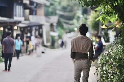 Rear view of people walking in city