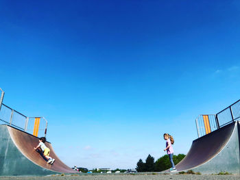 Siblings at skateboard park