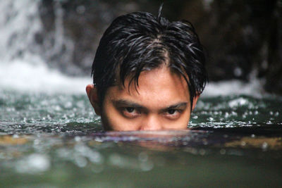 Close-up portrait of man swimming in water