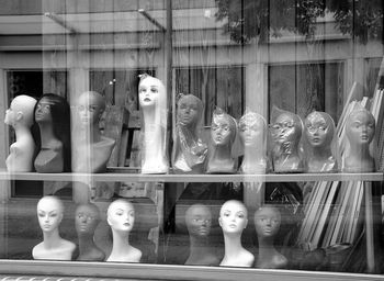 Mannequins in store seen through window