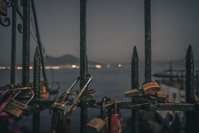 A railing overlooking the gulf of naples, padlocks have been left to represent the love of a couple.