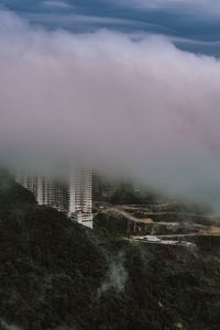 Cityscape against cloudy sky