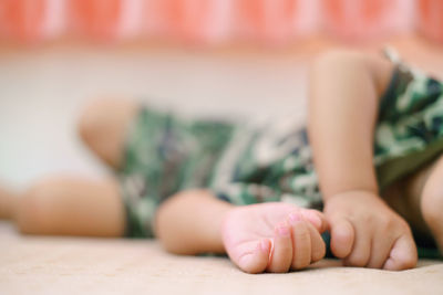 Close-up of baby lying on bed