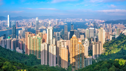 Aerial view of buildings in city against sky