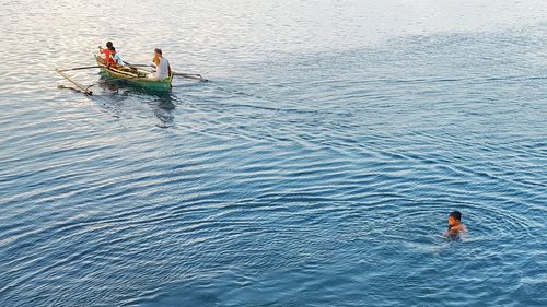 High angle view of people enjoying in sea