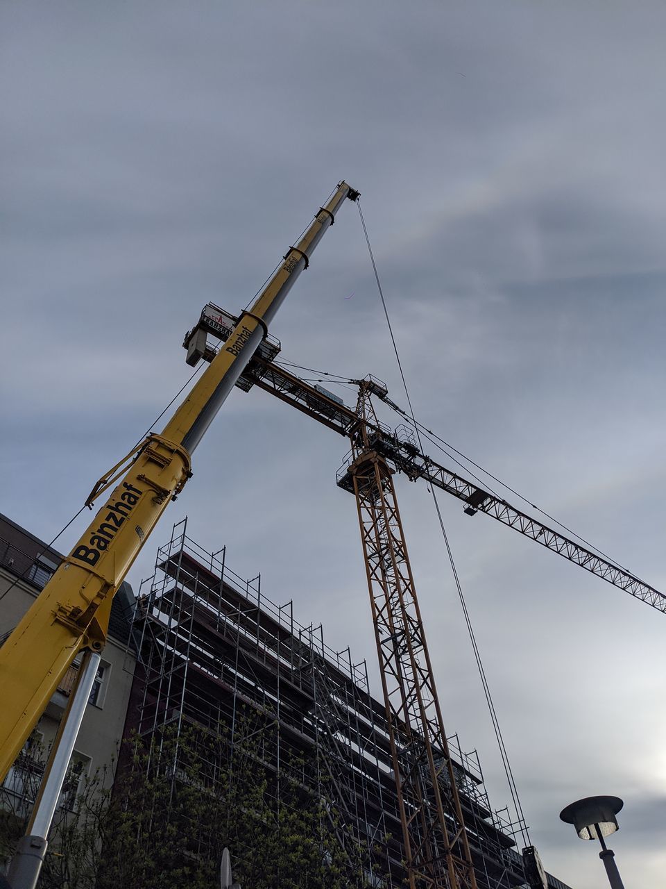 LOW ANGLE VIEW OF CRANE AGAINST SKY