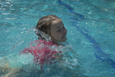 High angle view of boy swimming in pool