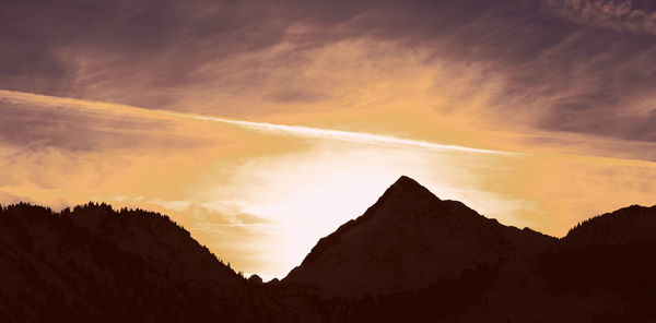 Low angle view of silhouette mountains against sky during sunset