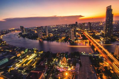 High angle view of city lit up at night