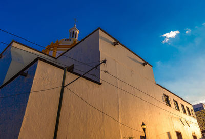 Low angle view of building against blue sky