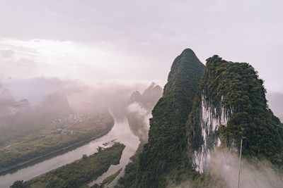 Hills under cloudy sky at sunrise, xingping town, guilin, china